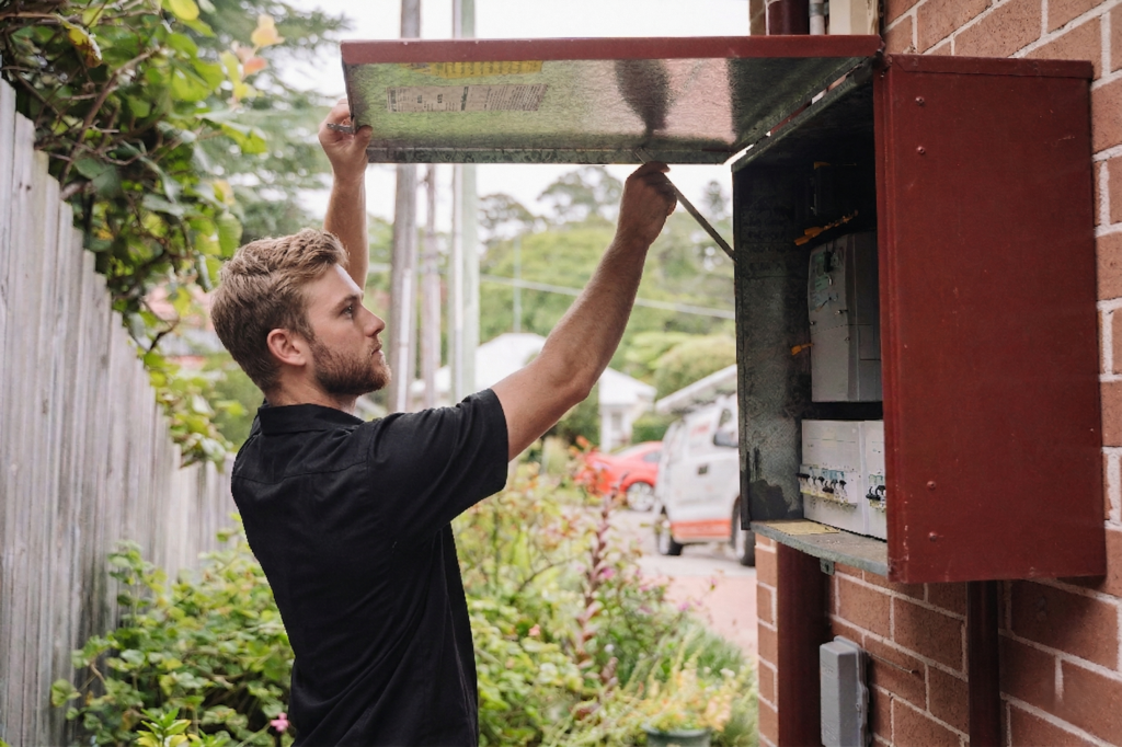 Electrician installing downlights in a Belmore home
